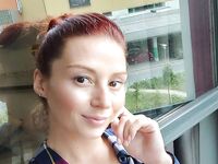 Redhead shows off her big boobs and tattoos while taking nudes